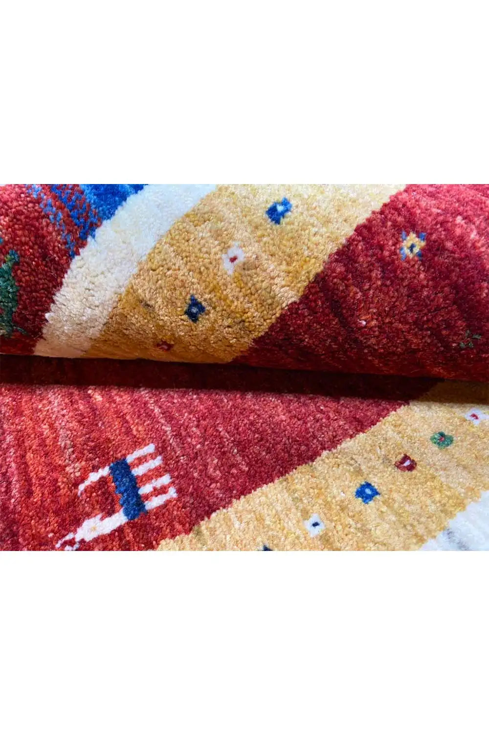 Gabbeh rug (123x80 cm) close-up: red/beige pile, multicolored embroidered motifs