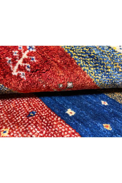 Gabbeh rug 156x101 cm close-up: coarse woven texture in red and blue