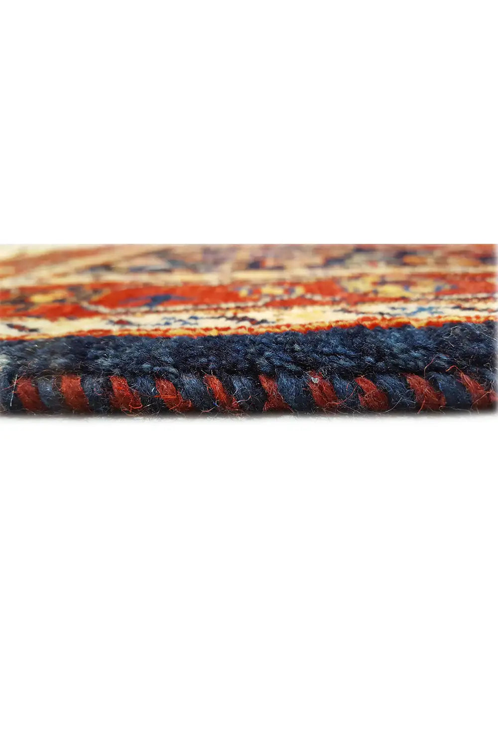 Carpet edge with a colorful woven pattern and visible pile texture