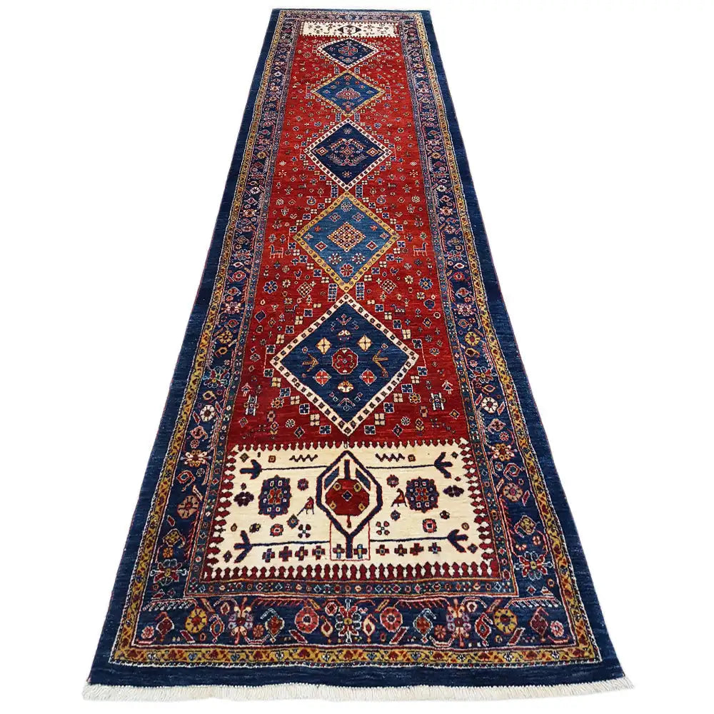 Oriental rug with a red central field, dark blue border, and geometric pattern