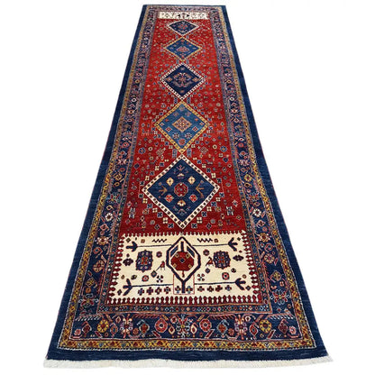 Oriental rug with a red central field, dark blue border, and geometric pattern