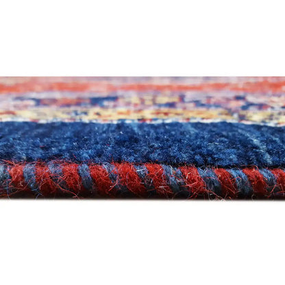 Rug edge detail: dense pile in blue and red with a contrasting inner border