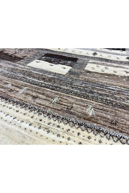 Rug detail: woven stripes and small ornaments in beige, gray, and dark brown