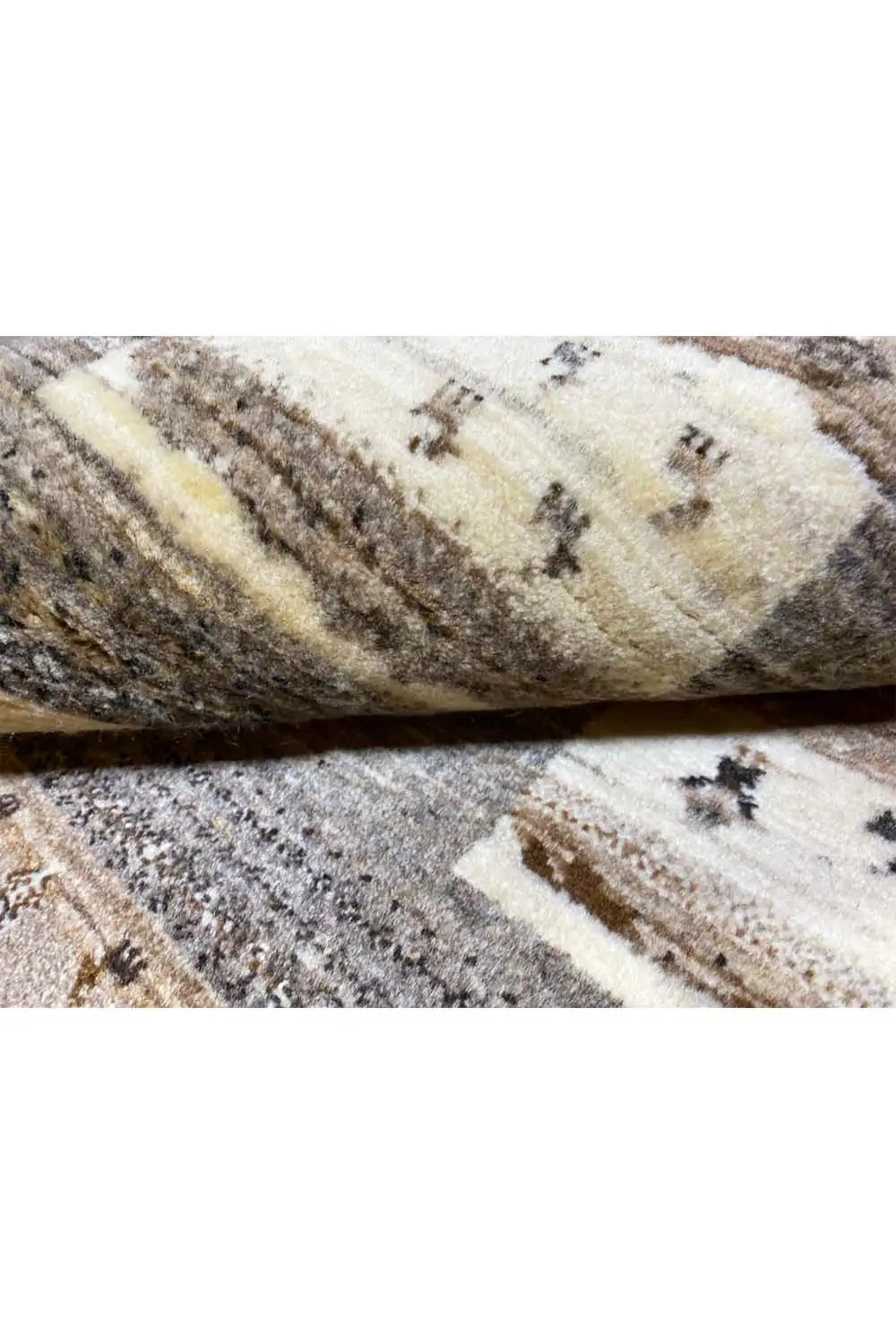Carpet detail showing pile and binding strip, beige with dark cross patterns