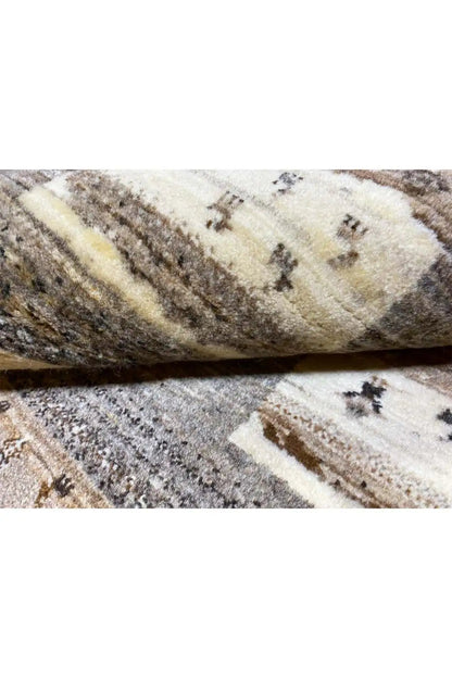 Carpet detail showing pile and binding strip, beige with dark cross patterns