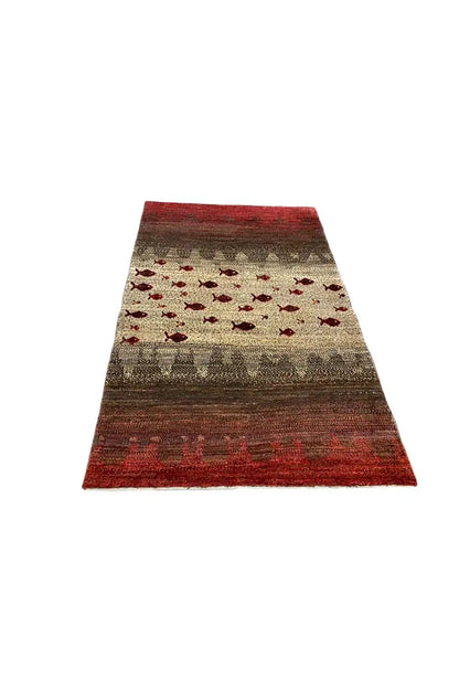 Gabbeh rug, red and beige with red fish patterns, narrow side view in rectangular format