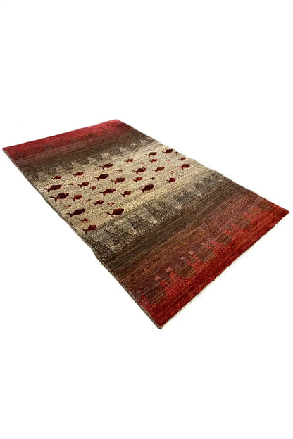 Gabbeh rug, rectangular, red and beige with red fish-motif panels and dark stripes