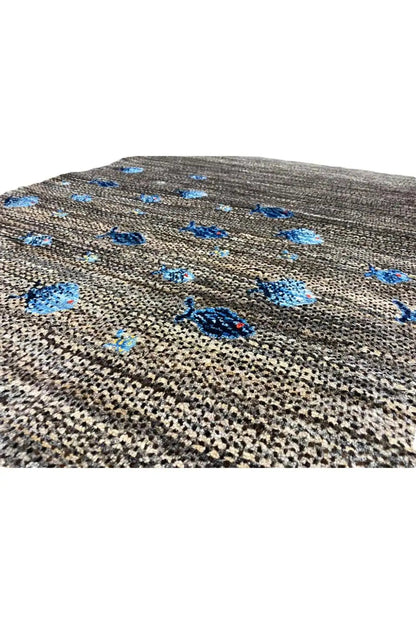 Gabbeh rug 128x82 cm, close-up: blue pattern on a dark mottled woven texture