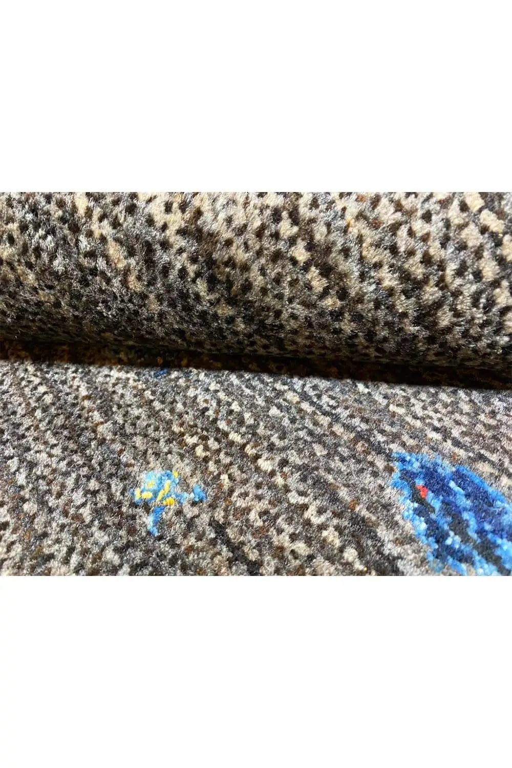 Gabbeh rug 128x82 cm, side detail: dark mottled texture with blue pattern