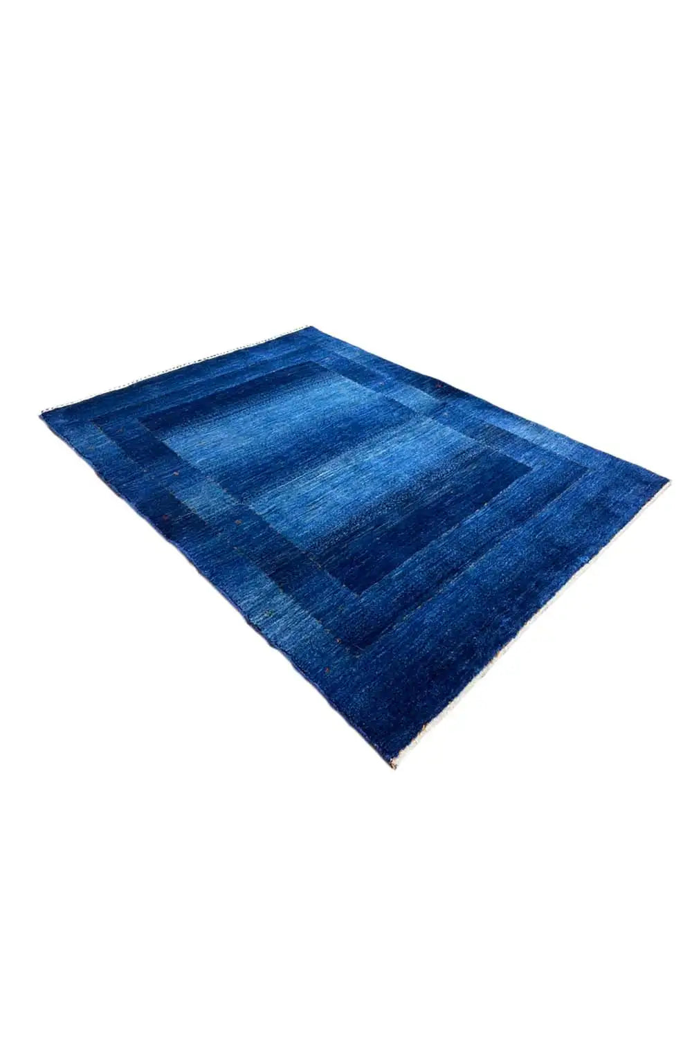 Blue Gabbeh rug with dark blue rectangular fields, diagonal view