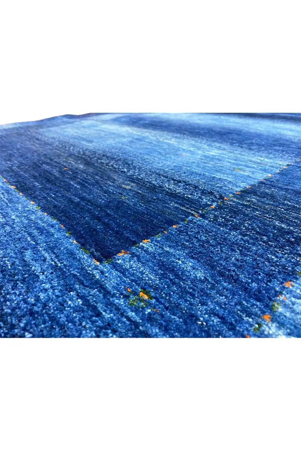 Blue Gabbeh rug with a fine pile texture and integrated flecks of color