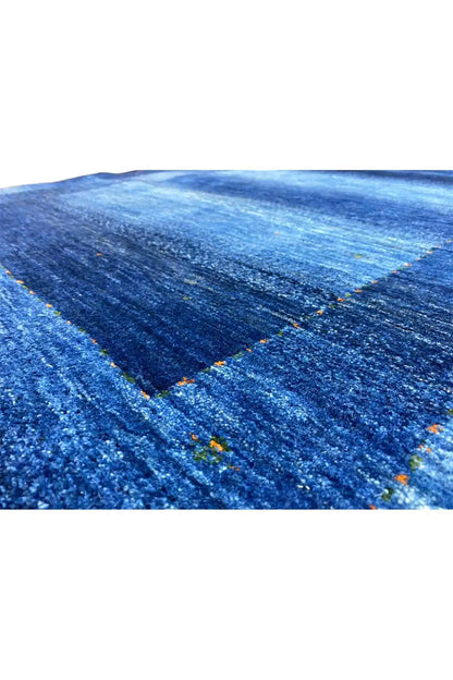 Blue Gabbeh rug with a fine pile texture and integrated flecks of color