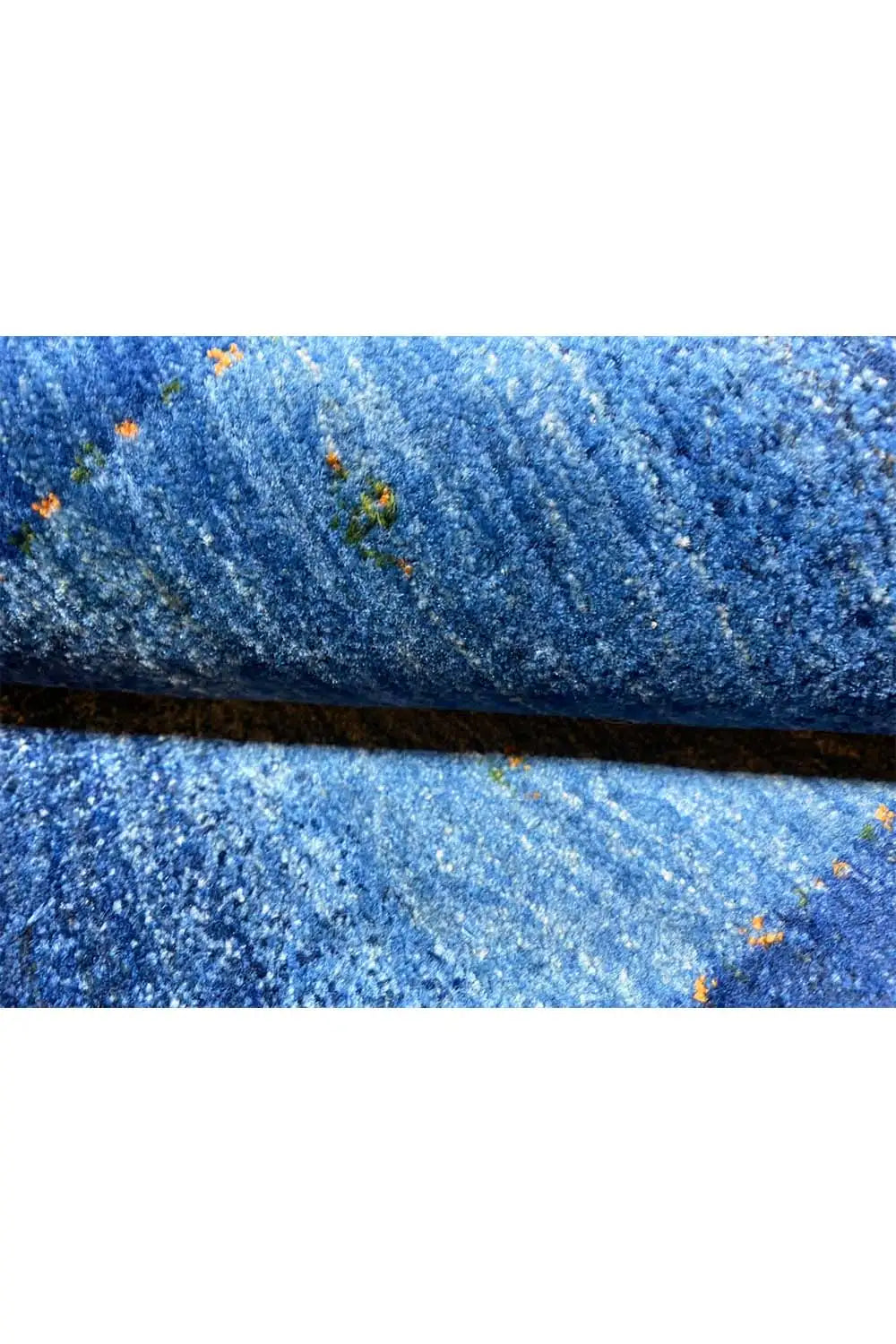Blue Gabbeh rug pile with a blue striped pattern and small colored dots