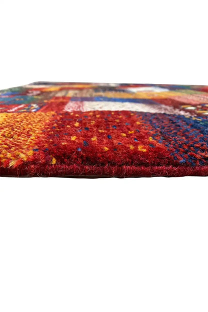 Gabbeh rug 130x86 cm side view: dense pile with red and blue patches of color