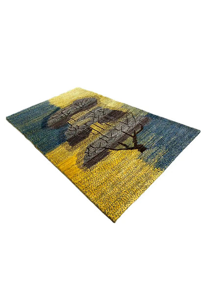Gabbeh rug 125x79 cm, blue-yellow with dark tree ornament in diagonal view