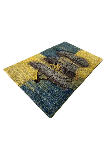 Gabbeh rug 125x79 cm with a blue-and-yellow speckled pattern and dark tree ornament