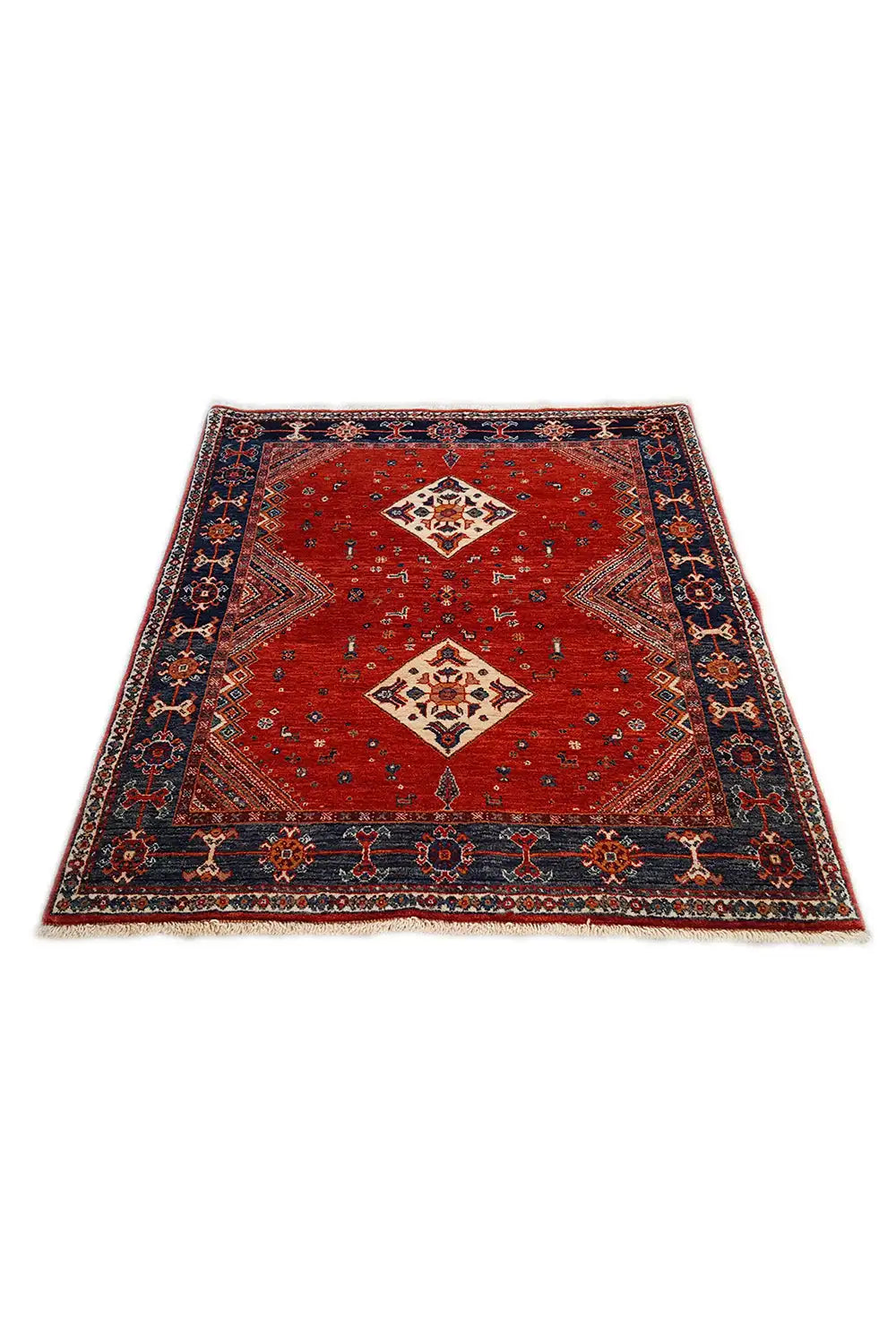 Red-and-blue carpet with central diamond motifs and a decorated border