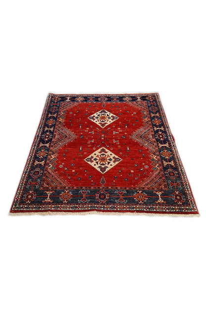 Red-and-blue carpet with central diamond motifs and a decorated border