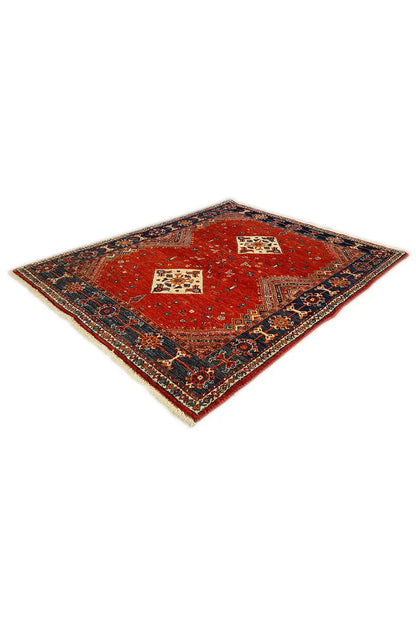 Square red rug with a blue ornamental border and two central diamond motifs