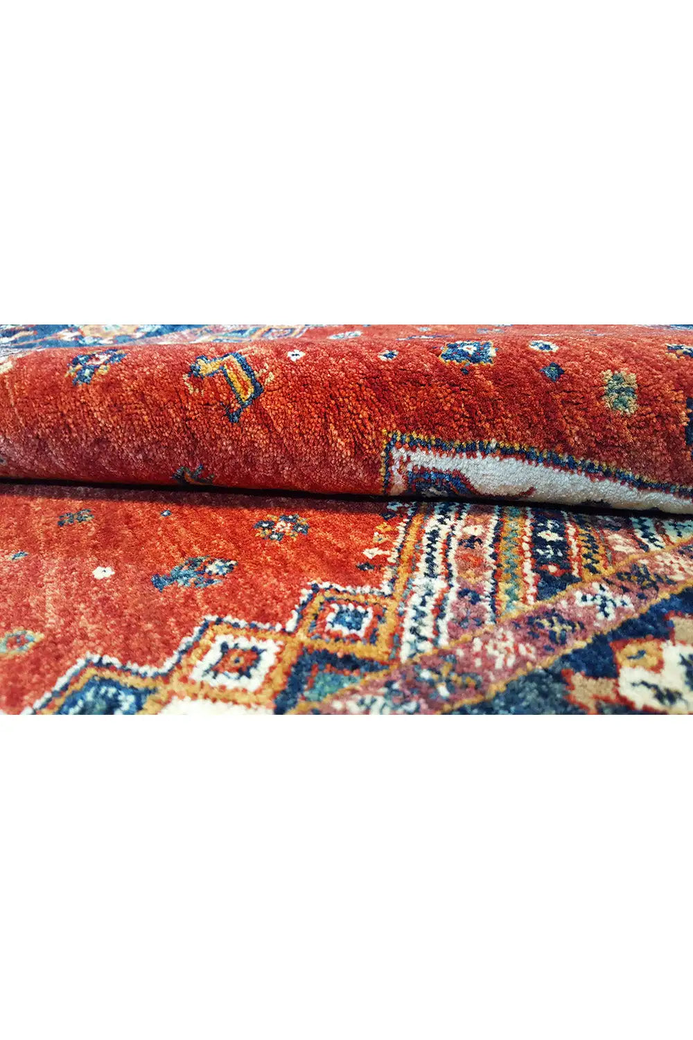 Close-up of a red carpet with multicolored patterns and a visible pile texture
