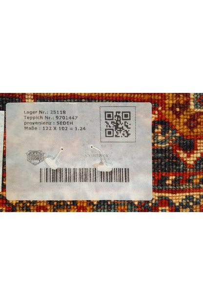 Label on the back of a rug with a QR code, surrounded by a colorful rug pattern