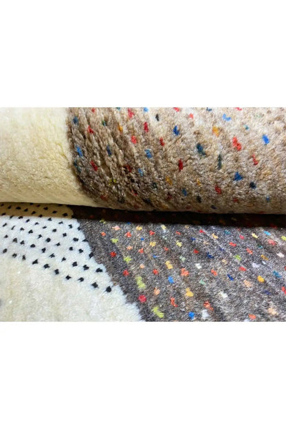 Gabbeh rug (132x84 cm) Detail: rolled edge, beige pile with colorful dots and dark areas
