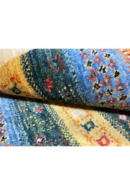 Carpet detail with a blue-orange pattern and fine pile at a folded section