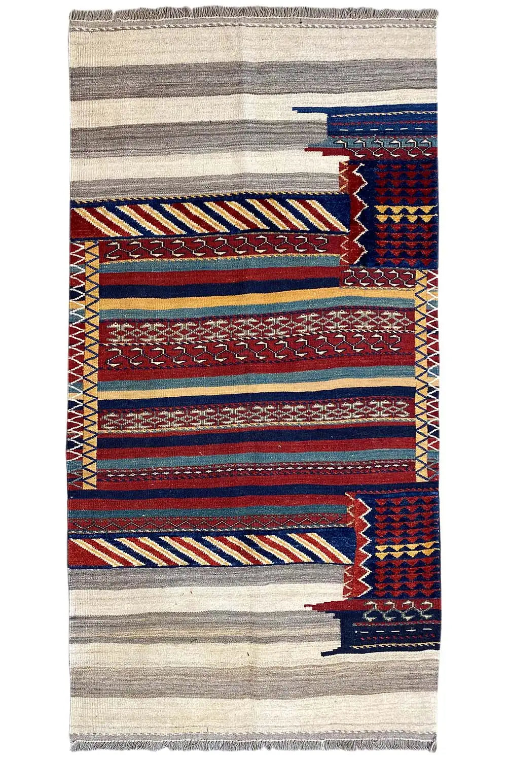 Rectangular kilim rug with a striped pattern in gray, blue, and red, with fringes.