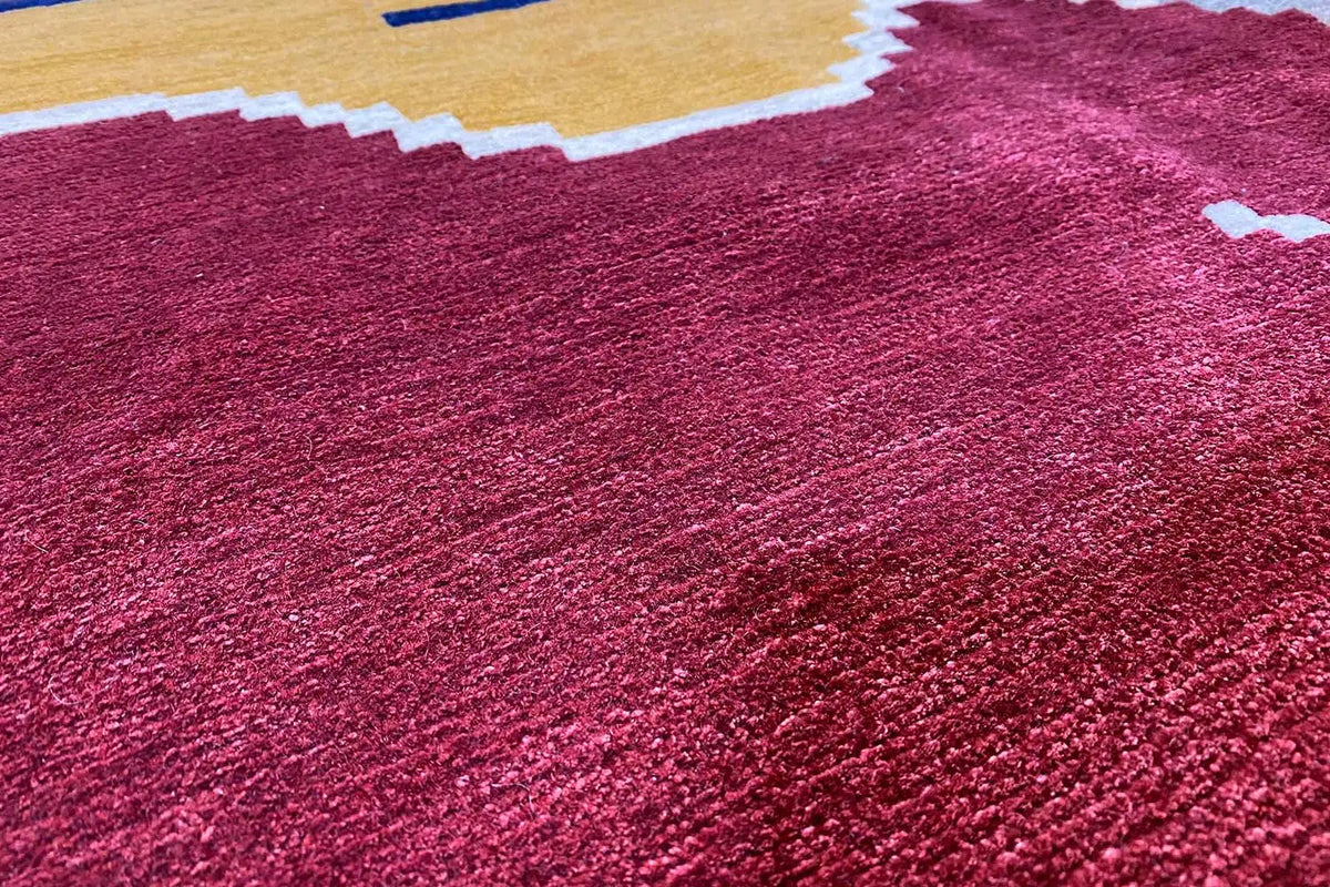 Designer rug Bo Hamsa: close-up of the rug pile, deep red with subtle color gradients
