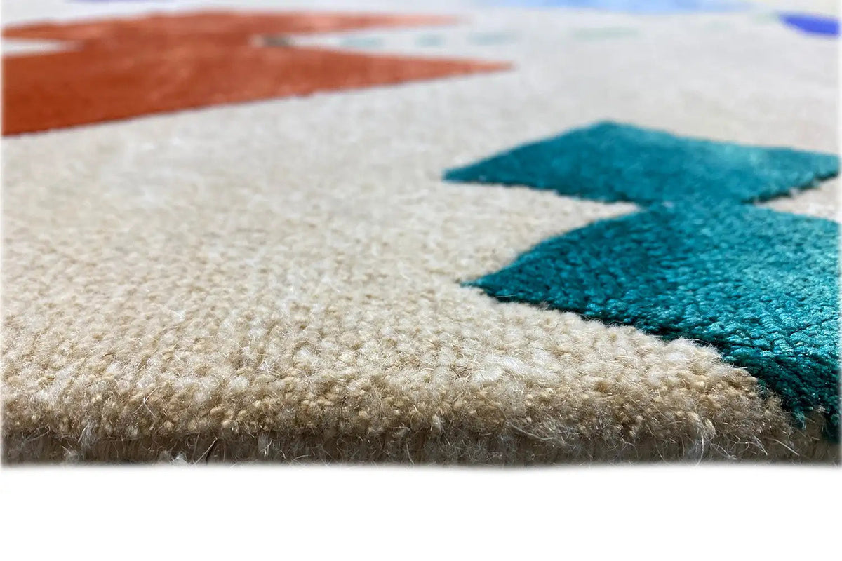 Close-up: beige carpet with blue-green accents and soft pile