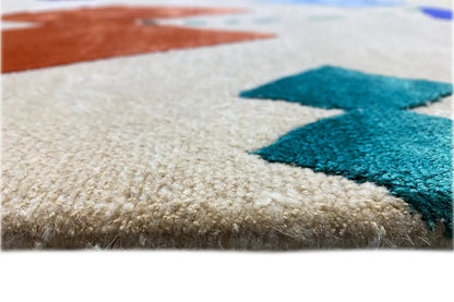 Close-up: beige carpet with blue-green accents and soft pile