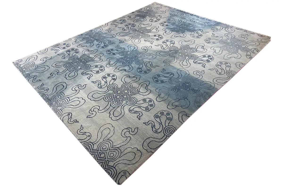 Designer rug with Bo-Hamsa design in blue and light gray, diagonal view
