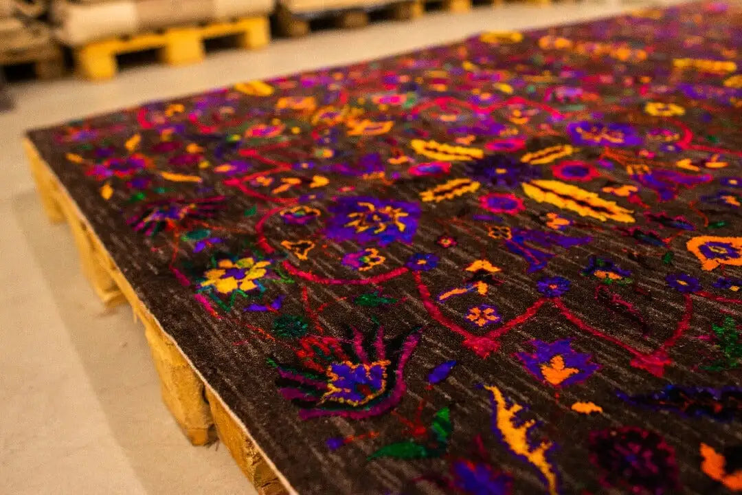 Silk sari: close-up of the colorful embroidered ornament details on dark fabric