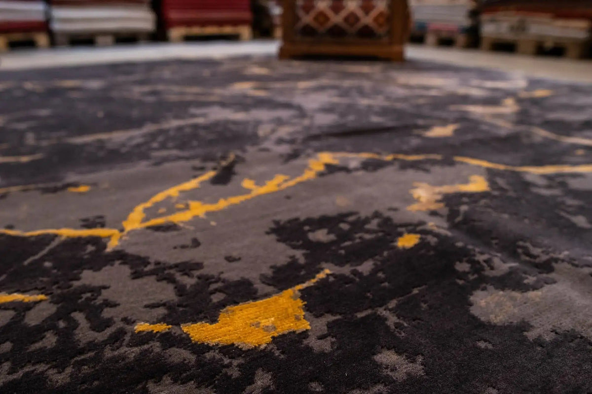 Close-up of the carpet surface: dark gray with yellowish marble streaks