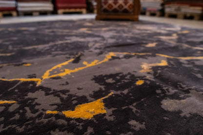 Close-up of the carpet surface: dark gray with yellowish marble streaks