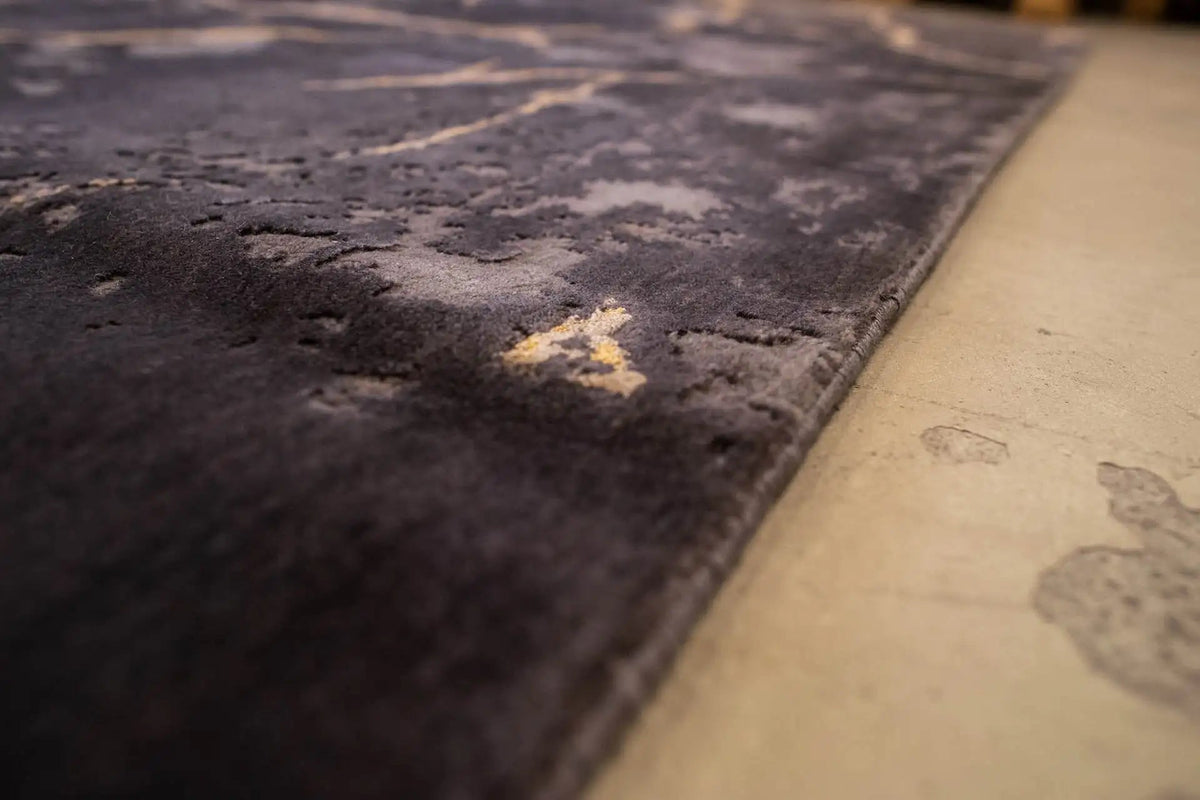 Carpet corner: dark gray with yellowish patches and marble-like veins