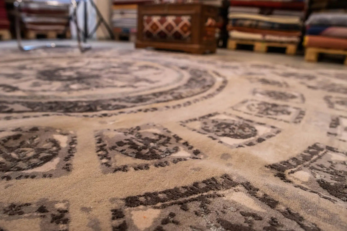 Carpet pattern in detail: repeated ornaments and border in beige and gray