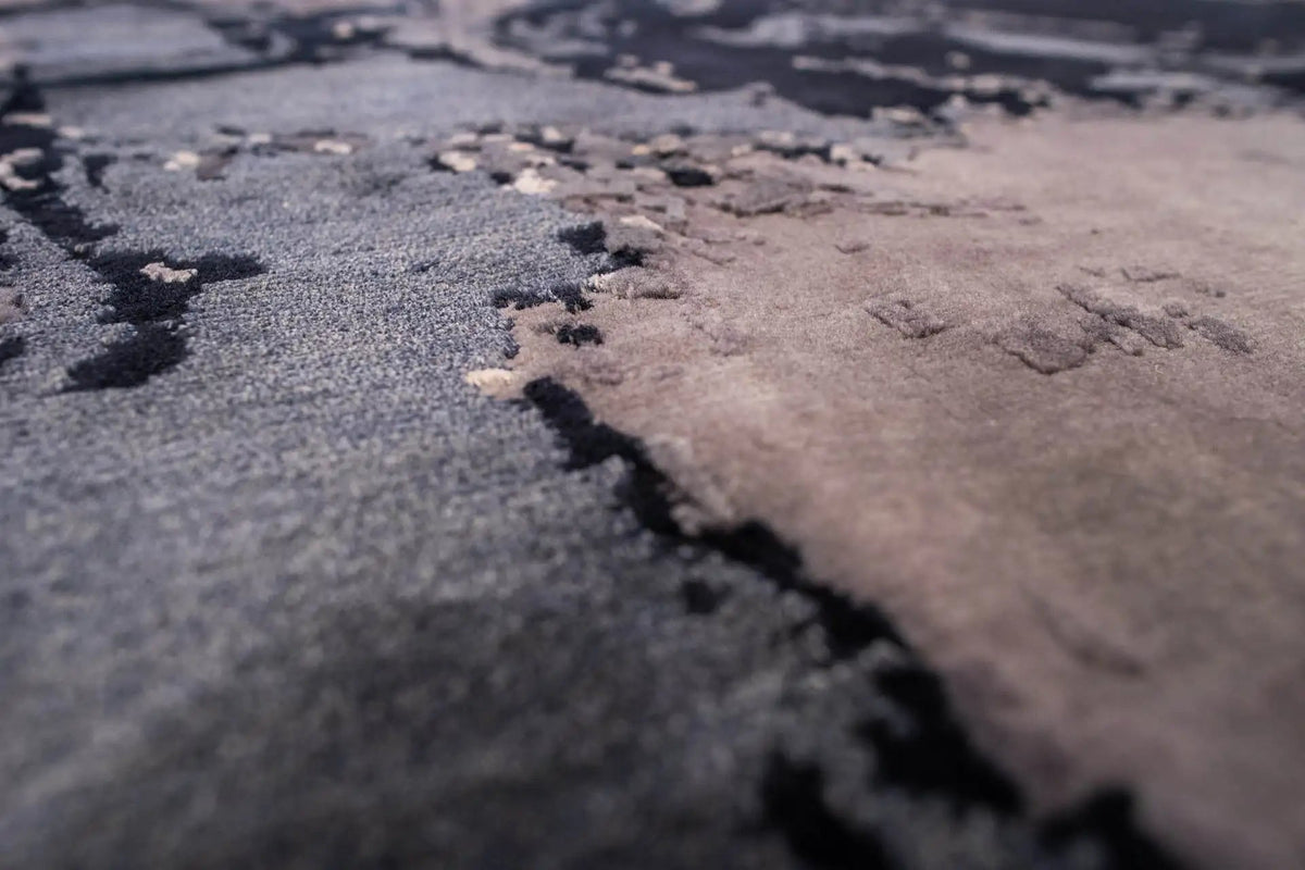 Close-up of carpet: pile texture with blended gray and dark blue tones