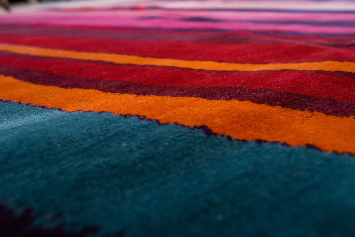 Close-up: multicolored stripes on a light background, velvety carpet surface