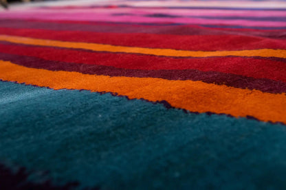 Close-up: multicolored stripes on a light background, velvety carpet surface