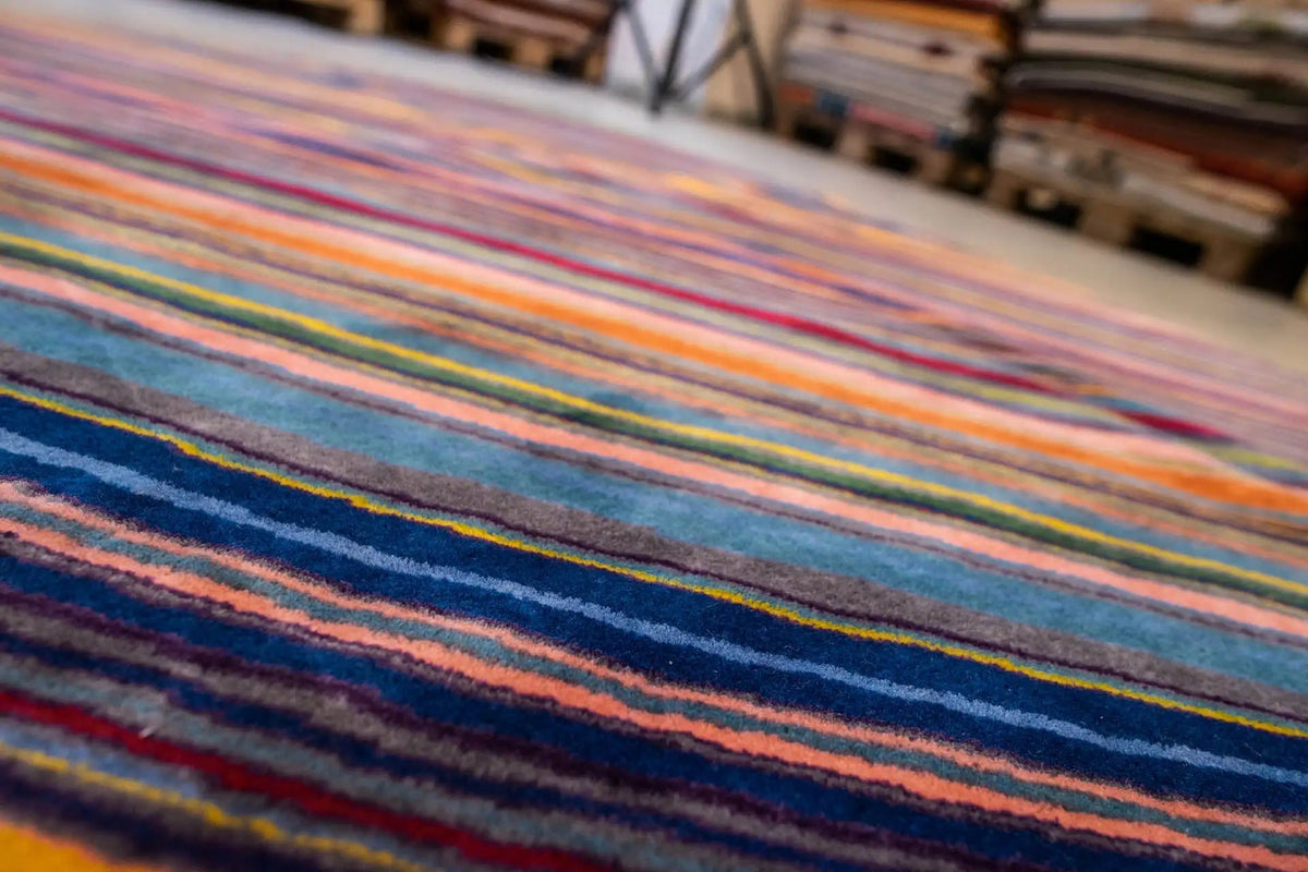 Close-up of a striped pattern: blue base fabric with colored lines