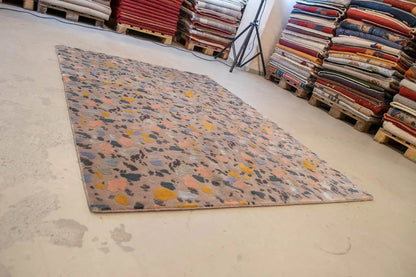 Designer rug Terrazzo by Pascal Walter on the floor, colorful pattern made of fragments