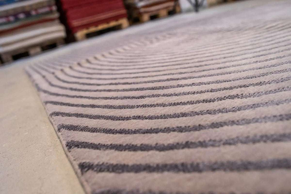 Carpet detail with a gray background and dark blue lines across the pile surface