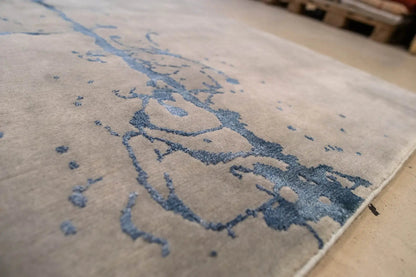 Detailed view of the pattern: gray carpet with a blue ink line and color gradients.