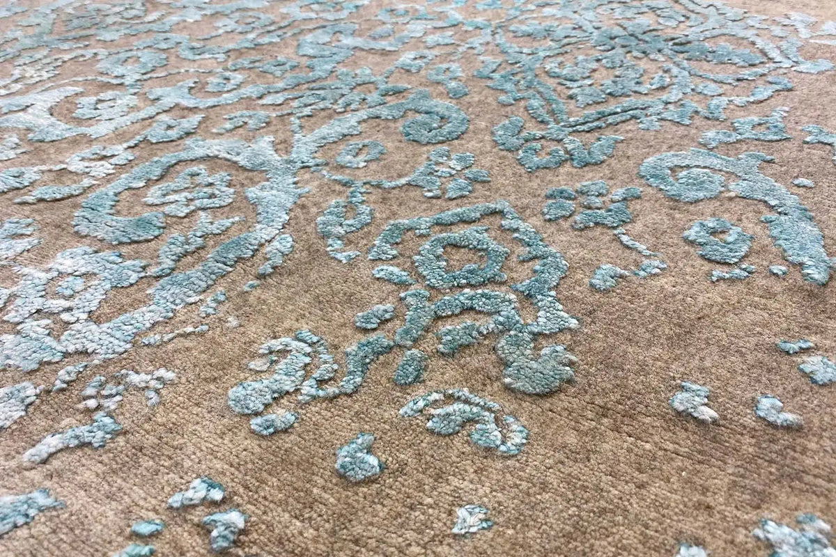 Carpet detail with floral ornaments in turquoise on a beige pile