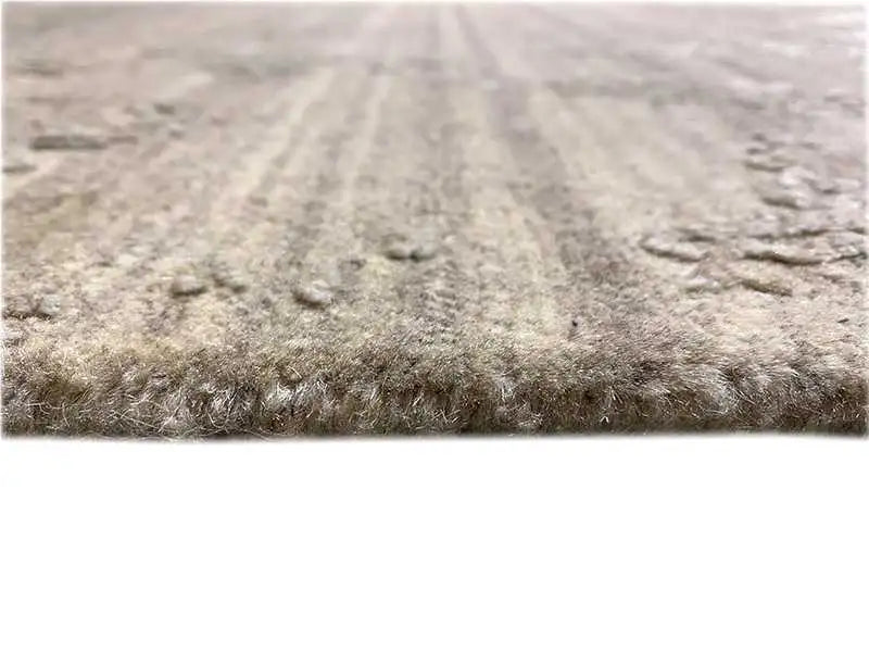 Carpet surface with a dense, mottled gray-beige pile texture