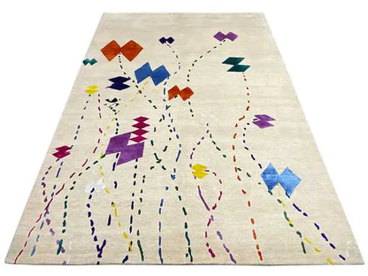 Beige rug with a large abstract pattern of lines and color blocks