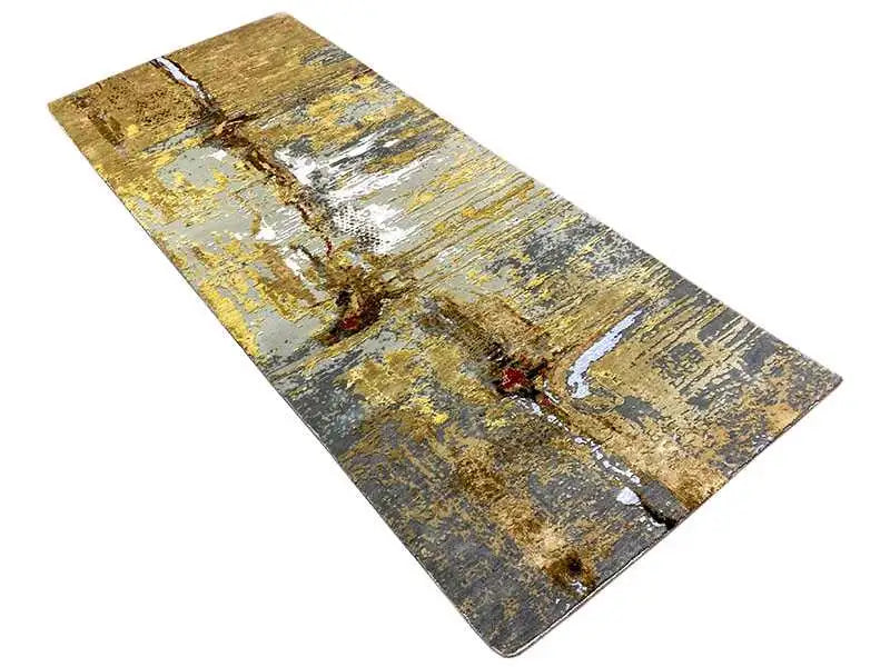 Rug with an abstract vintage design in gold, blue and gray, with a mottled texture