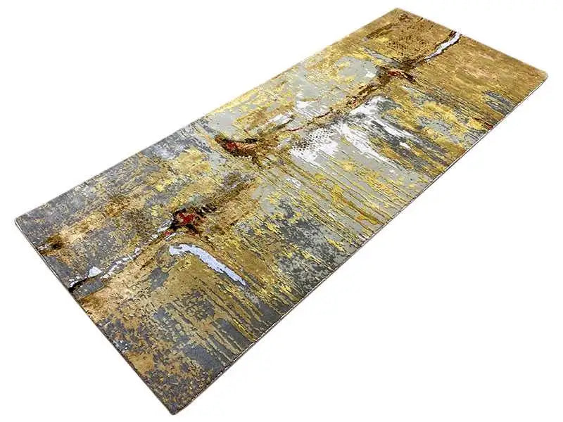 Rug with gold and blue-gray brushstroke patterns, shiny flecked look