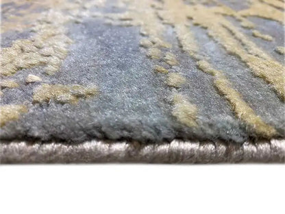 Carpet edge with a soft pile in gray-blue and beige flecks